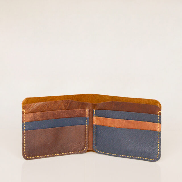 Inside view of bifold wallet showing 6 card slots and a note compartment. Made of upcycled brown, tan and blue leather with yellow stitching