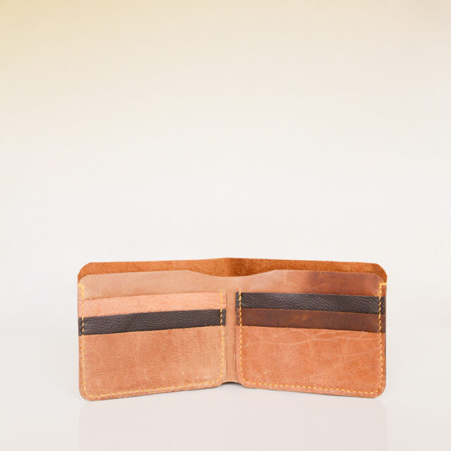 Open view of bifold wallet made from vintage tan and black leather and hand stitched with yellow linen thread