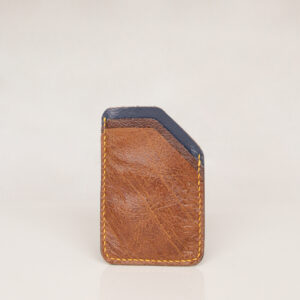 Front view of minimalist card wallet made from reclaimed and upcycled leather. Rectangular shape with missing corner in tan brown and blue leather with yellow stitiching