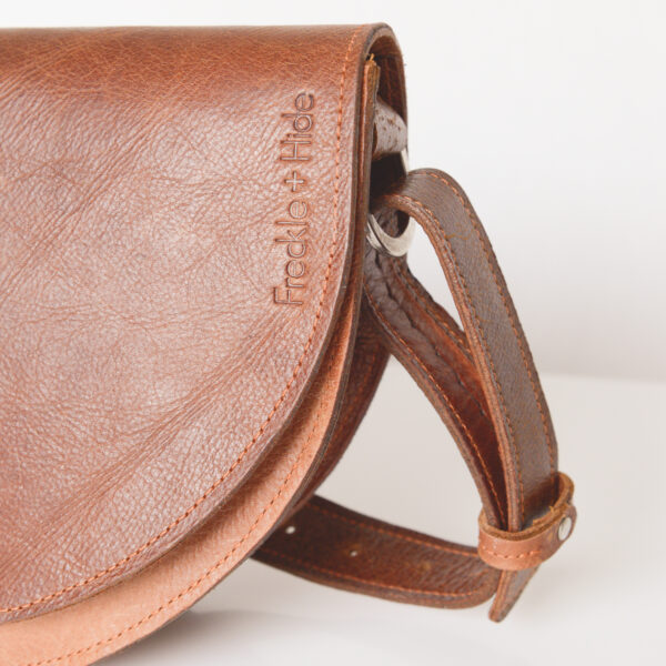 Handmade tan leather shoulder bag with silver hardware and adjustable strap