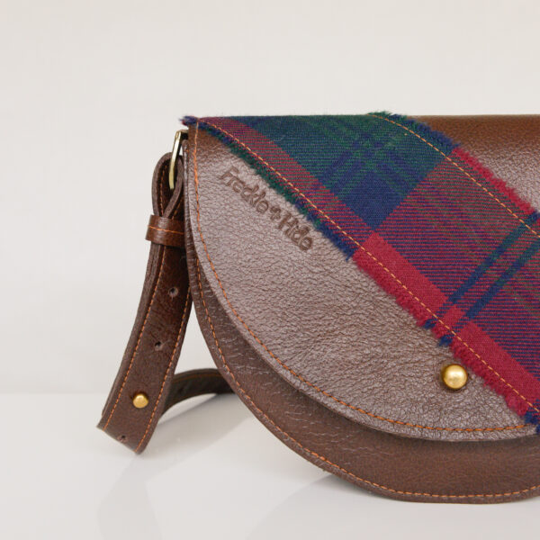 Brown bag made from upcycled leather with tartan across flap and on strap