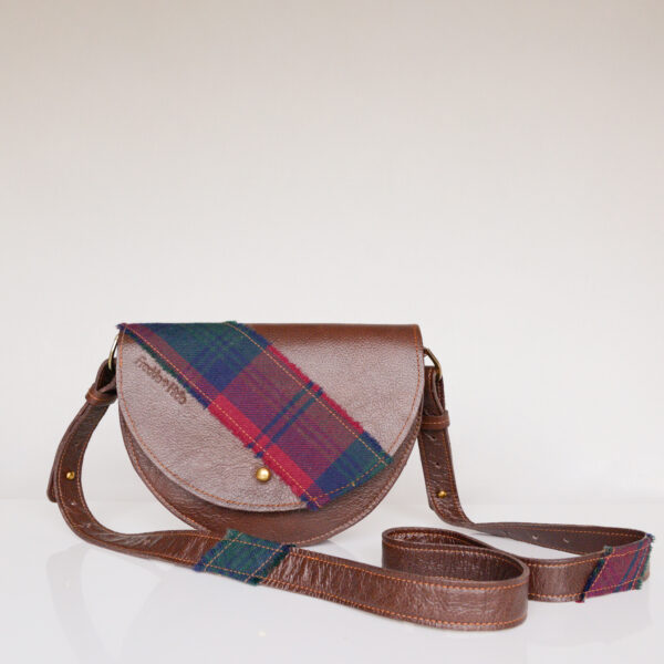 Brown bag made from upcycled leather with tartan across flap and on strap