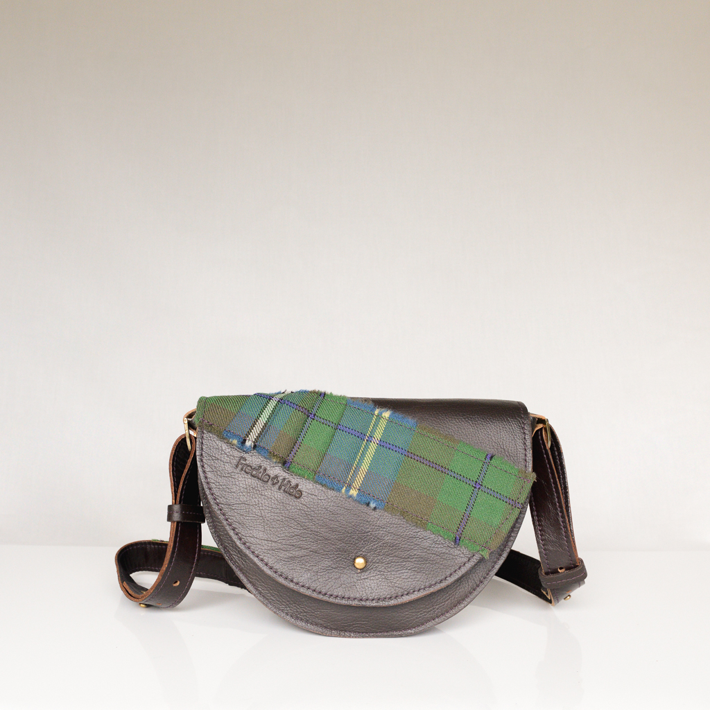 Unique dark brown shoulder bag made from upcycled leather with green tartan across flap and on strap