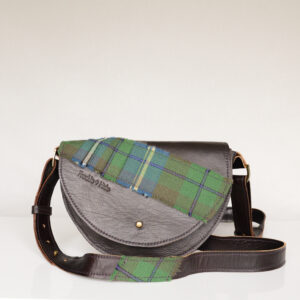 Handmade dark brown shoulder bag made from reclaimed and upcycled leather with green tartan across flap and on the adjustable strap