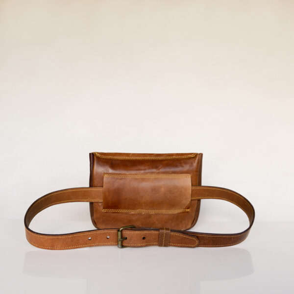 Tan leather waist bag with matching belt. Made from repurposed leather and featuring an antique brass buckle