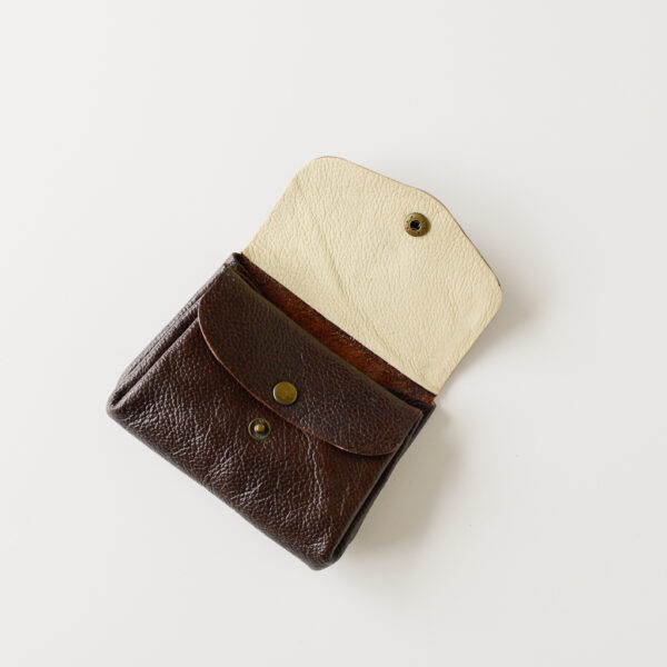 Dark brown leather wallet. Shown with main flap open to reveal contrasting cream leather lining on the inside of the pocket