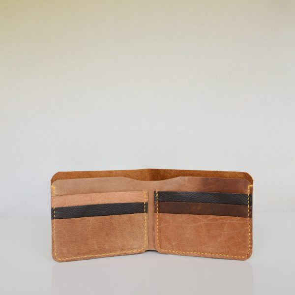 Open view of bifold wallet made from vintage tan and black leather and hand stitched with yellow linen thread
