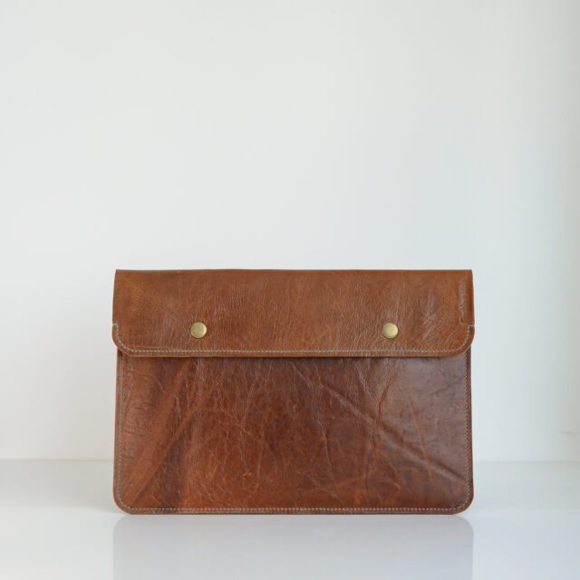 Recycled leather laptop sleeve in brown with blue contrast stitching
