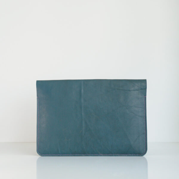 Rear view of reclaimed leather laptop case in blue with pink stitching