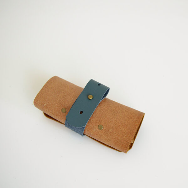 Tan and blue cable tidy made from reclaimed and recycled leather