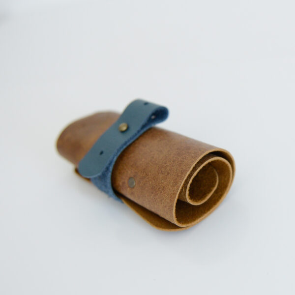 Tan and blue cable tidy made from reclaimed and recycled leather
