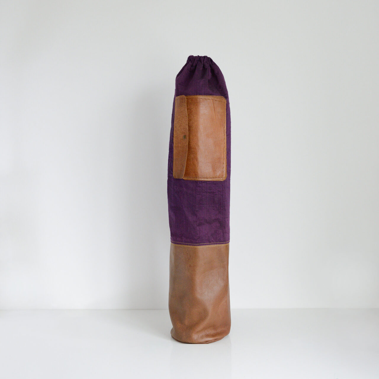Yoga mat bag made from upcycled leather and reclaimed purple shot silk with yellow stitching